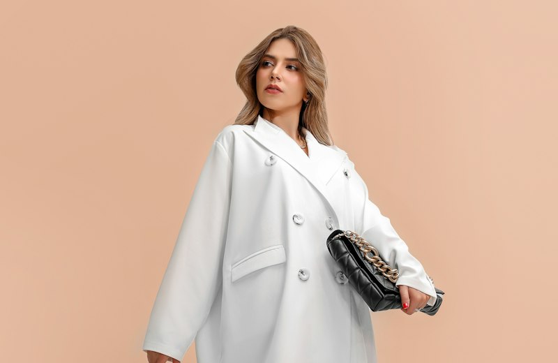Woman in a white wool coat and black boots